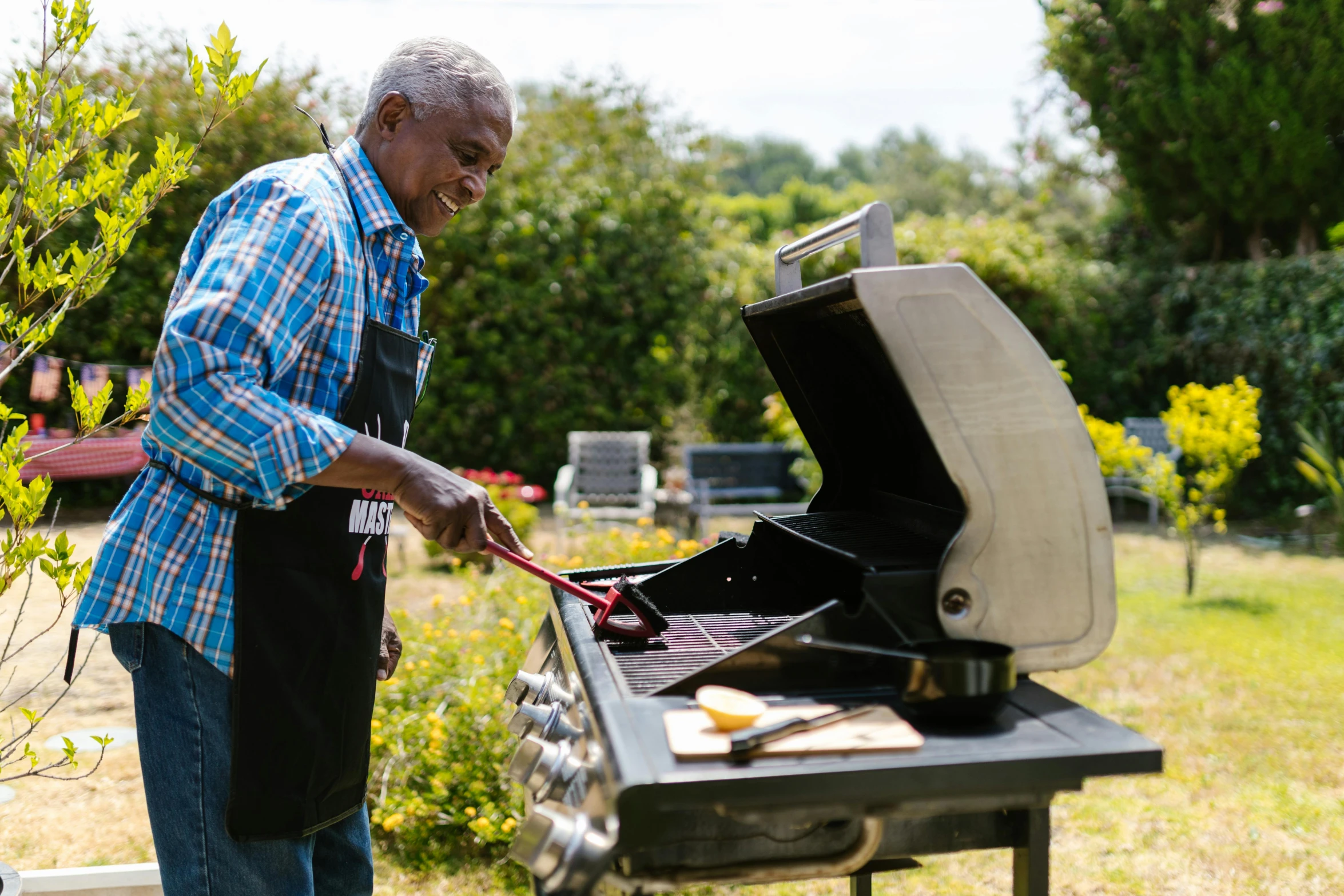 a man cooking food on a grill outside, pexels contest winner, black man, he is about 8 0 years old, 15081959 21121991 01012000 4k, epicurious