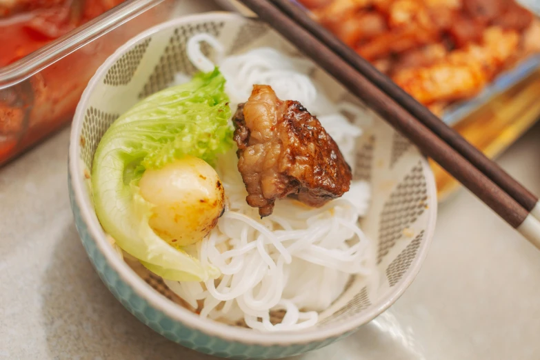 a close up of a bowl of food with chopsticks, square, offering a plate of food, chicken, date