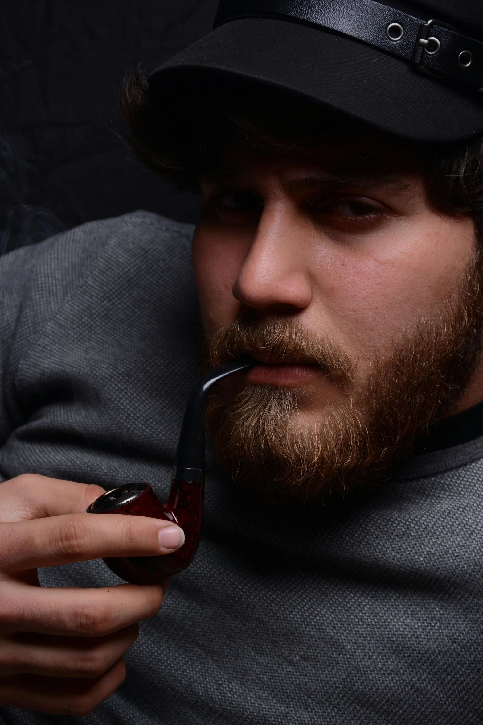 a man in a hat is smoking a pipe, an album cover, trending on pexels, hyperrealism, bearded beautiful man, gaming, british gang member, gray men