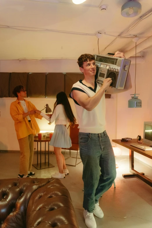 a man standing in a living room holding a radio, an album cover, by jeonseok lee, trending on pexels, happening, 3 actors on stage, standing in a server room, petra collins, set photo in costume