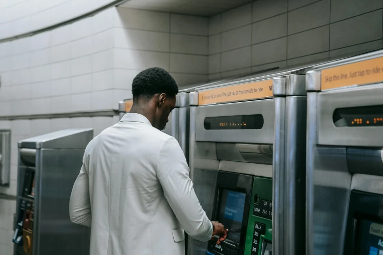 a man standing in front of an atm machine, by Carey Morris, pexels contest winner, wakanda, supersonic trains and passengers, ignant, summertime