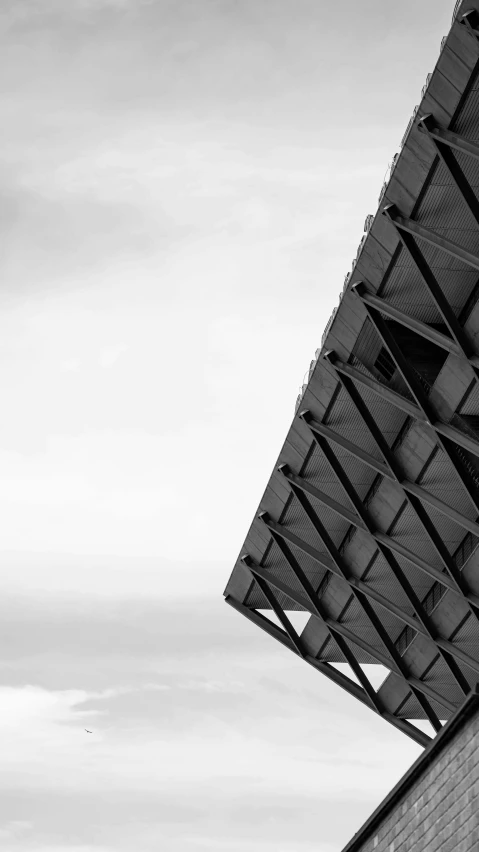 a black and white photo of a building, by Dave Allsop, unsplash, triangular face, square, view from the side”, high quality photo