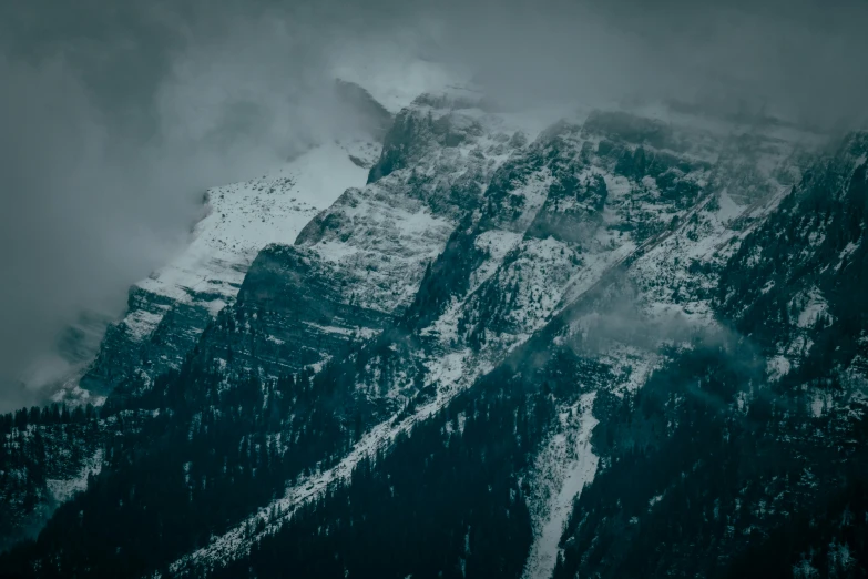 a mountain covered in snow under a cloudy sky, pexels contest winner, baroque, dark, banff national park, cold texture, stacked image