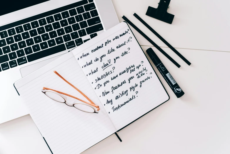 an open notebook sitting on top of a desk next to a laptop, unsplash contest winner, arbeitsrat für kunst, black marker, white background”, background image, various items