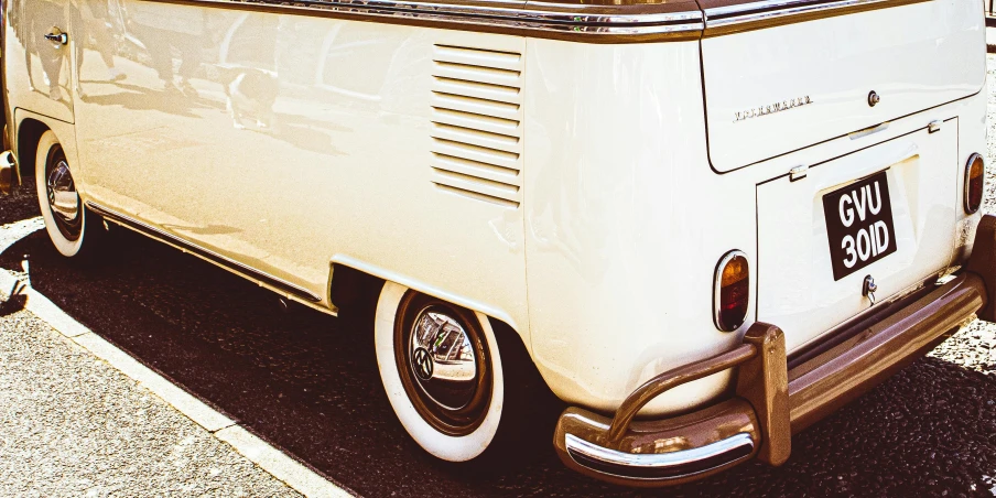 a white vw bus parked on the side of the road, pexels contest winner, retrofuturism, brown and cream color scheme, vintage closeup photograph, tail lights, white pearlescent