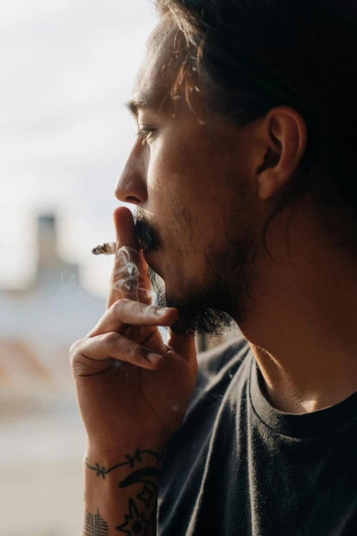 a man with long hair smoking a cigarette, pexels contest winner, pot leaf, on ship, asian male, smooth chin