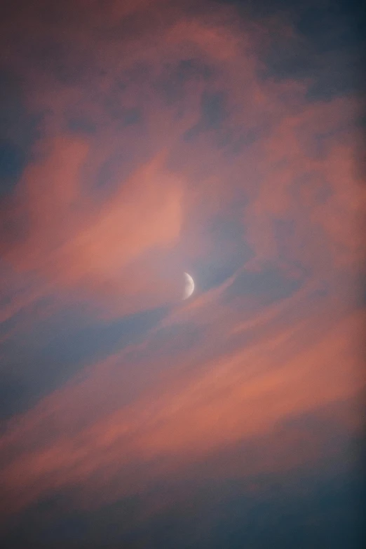 a plane flying in the sky with the moon in the background, by Jim Manley, aestheticism, dramatic pink clouds, color photograph, crescent moon, soft colors mono chromatic