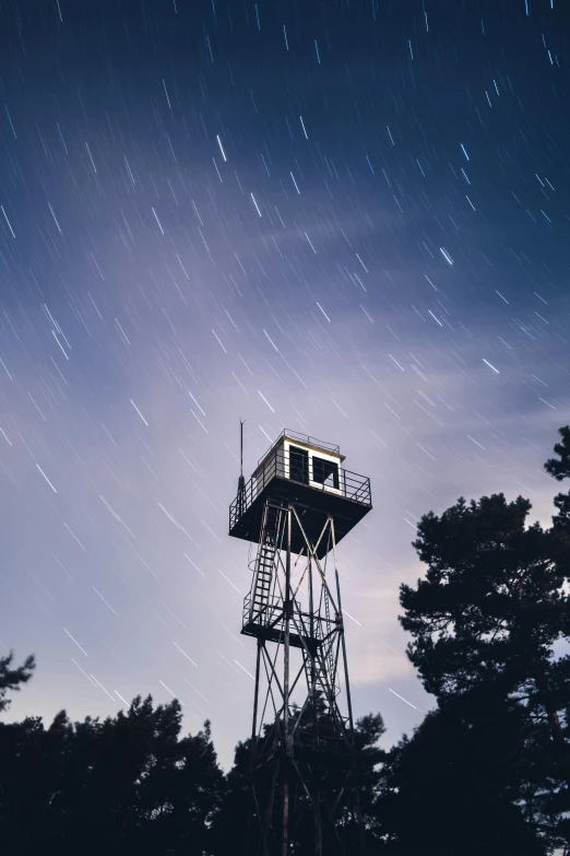 a tall tower sitting in the middle of a forest, by Jesper Knudsen, unsplash, set in observatory at night, military outpost, alabama, star rain