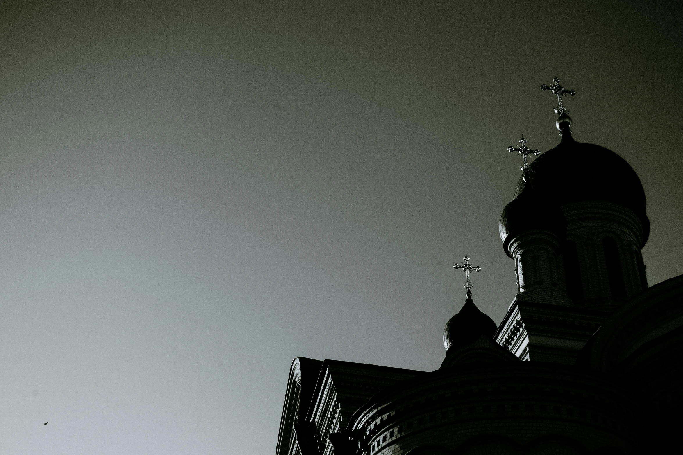 a black and white photo of a clock tower, by Ihor Podolchak, unsplash, baroque, dark gloomy church, orthodox christianity, silhouette :7, domes