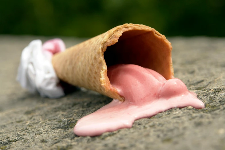 an ice cream cone with pink icing sticking out of it, by Doug Ohlson, unsplash, spilling ketchup, excrement, covered with pink marzipan, silent hill in real life