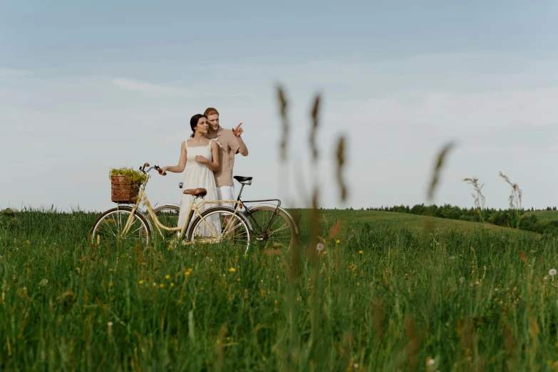 a woman standing next to a bike in a field, pexels contest winner, happy couple, avatar image, people on a picnic, ad image