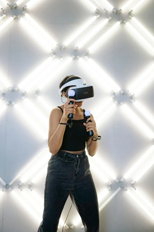 a woman standing in front of a wall wearing a virtual reality headset, festival vibes, siggraph, k-pop, onyx