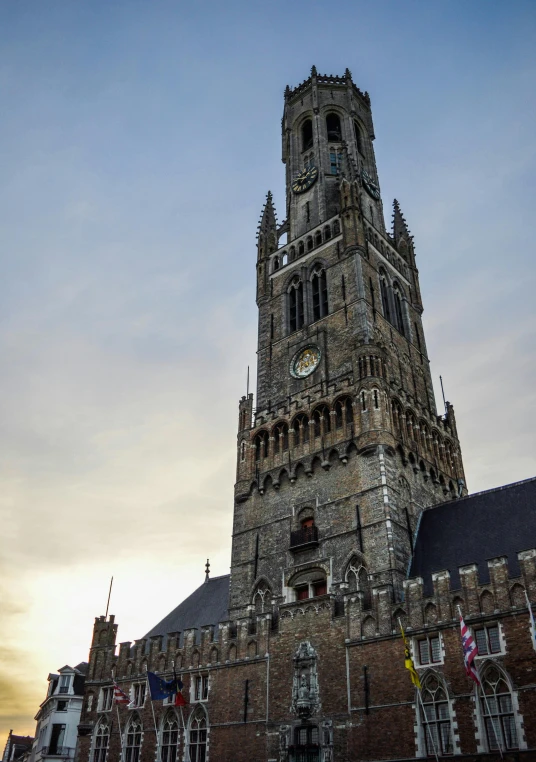 a tall tower with a clock on top of it, by Jan Tengnagel, pexels contest winner, renaissance, flanders, exterior, dry archways and spires, early evening