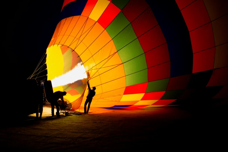 a person standing in front of a hot air balloon, by Peter Churcher, pexels contest winner, interactive art, back lit lighting, everyone having fun, outside on the ground, rich vivid color