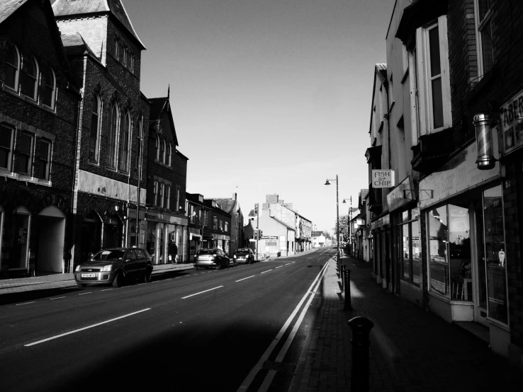 a black and white photo of a city street, by David Donaldson, swanland, beautiful weather, dawn mcteigue, sleepy