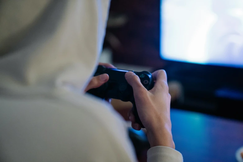 a person holding a video game controller in front of a tv, unsplash, wearing a dark hood, 15081959 21121991 01012000 4k, 2 5 6 x 2 5 6 pixels, among us crewmate