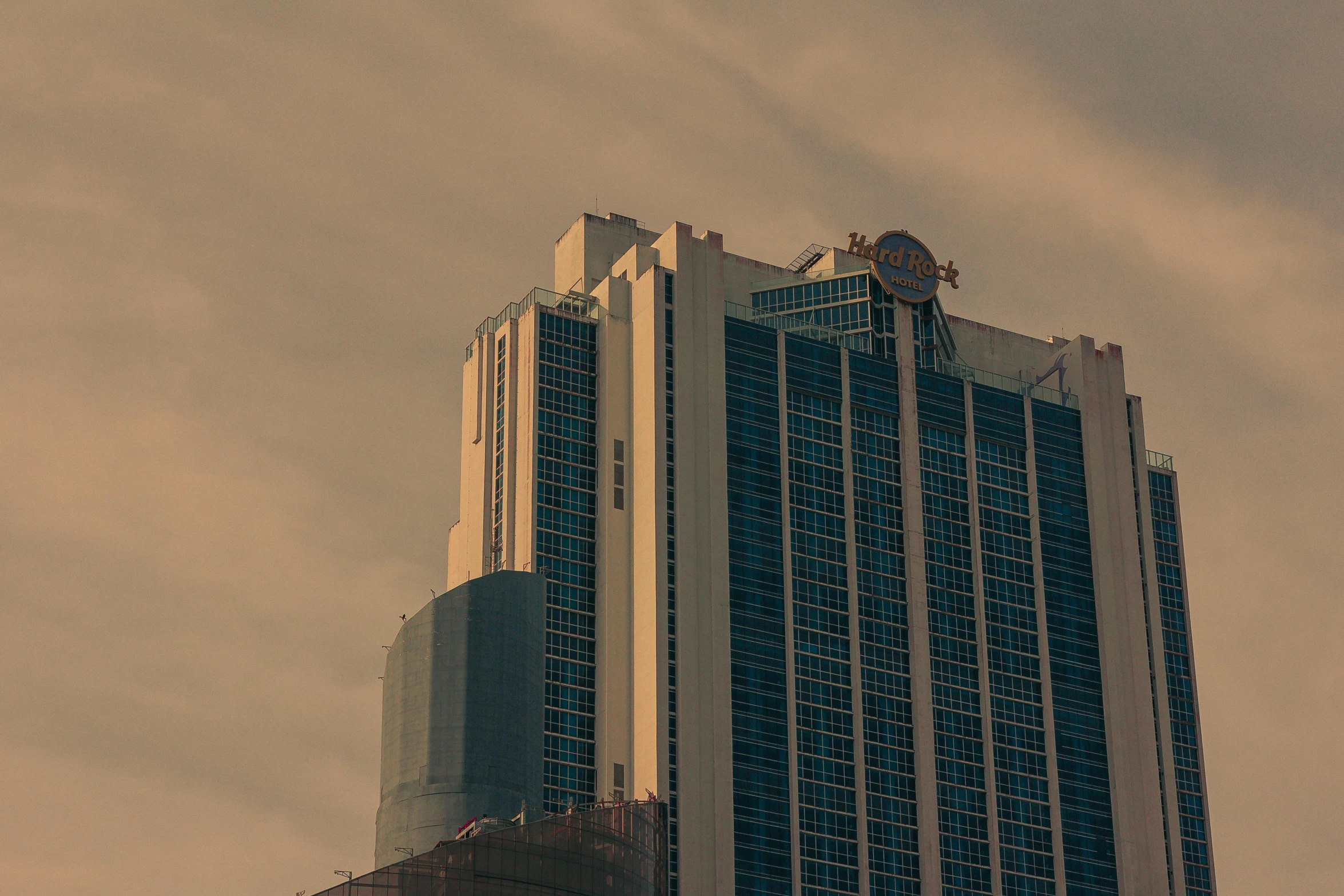 a tall building with a clock on top of it, pexels contest winner, casino, sunfaded, sky scrapers, 2045