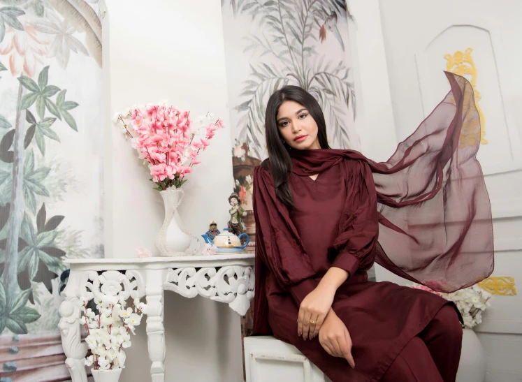 a woman sitting on a chair in a room, inspired by Ambreen Butt, featured on instagram, dau-al-set, maroon accents, chiffon, thumbnail, 3 - piece