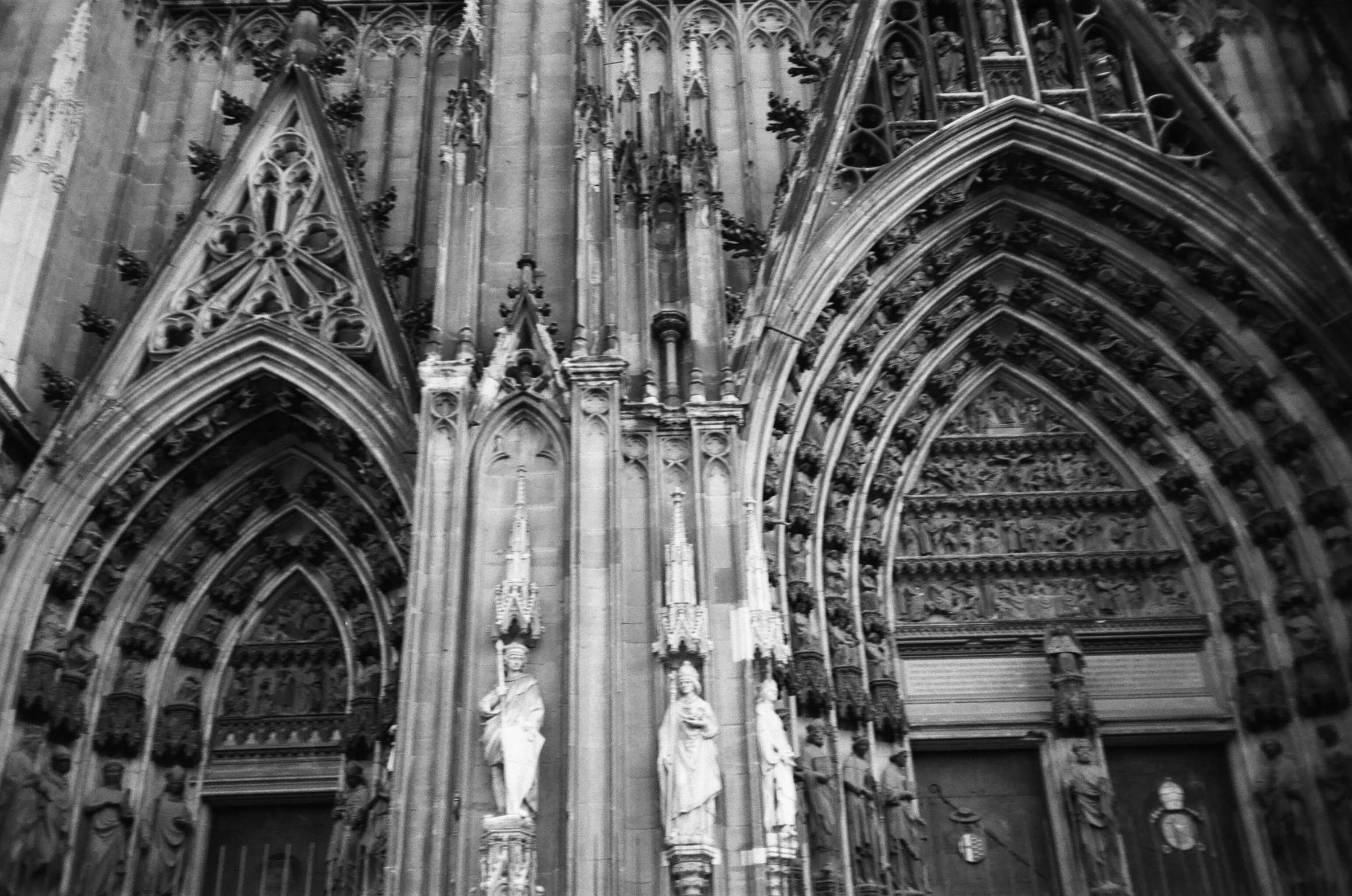 a black and white photo of a cathedral, a black and white photo, by Caroline Mytinger, gothic art, large stone statues of heroes, high details photo, front and side views, many details