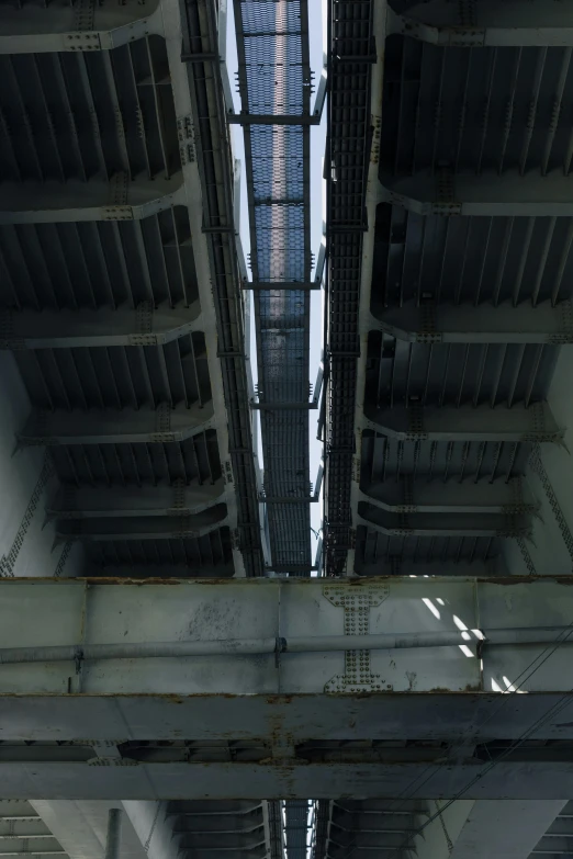 an overhead view of the underside of a bridge, inspired by Andreas Gursky, brutalism, on aircraft carrier, pipes, opposite the lift-shaft, ( mechanical )