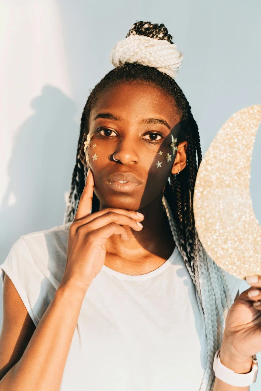 a woman holding up a sign with a crescent on it, trending on pexels, afrofuturism, glittering skin, nonbinary model, profile image, skincare