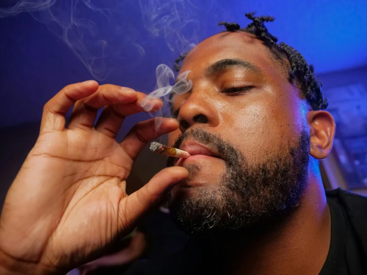 a man smoking a cigarette in a dark room, an album cover, by Stokely Webster, trending on pexels, marijuana buds, at the party, playboi carti portrait, threyda