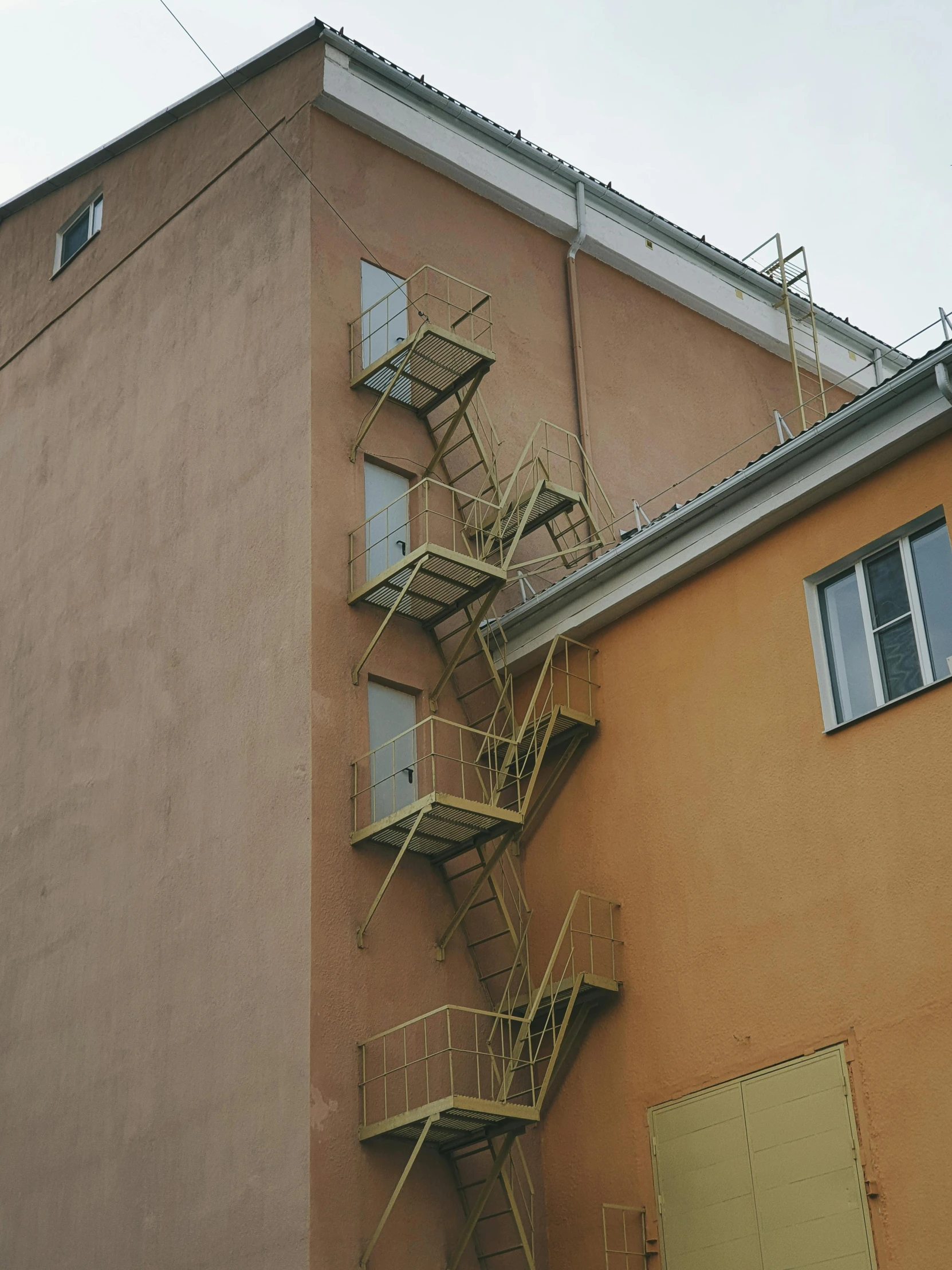 a fire escape staircase on the side of a building, by Emma Andijewska, helsinki, low quality photo, 🚀🌈🤩, 3 4 5 3 1