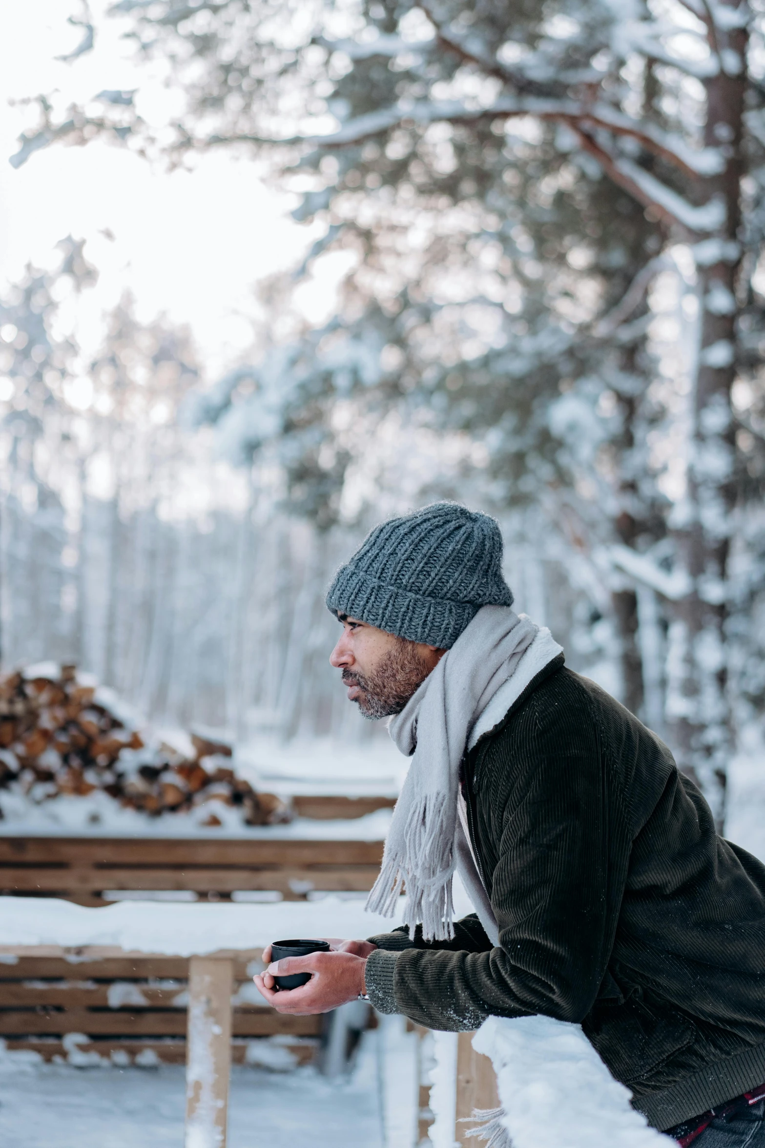 a man riding a snowboard down a snow covered slope, inspired by Einar Hakonarson, pexels contest winner, fine art, at a campfire in the forest, thoughtful expression, sitting on a wooden dock, knitted hat