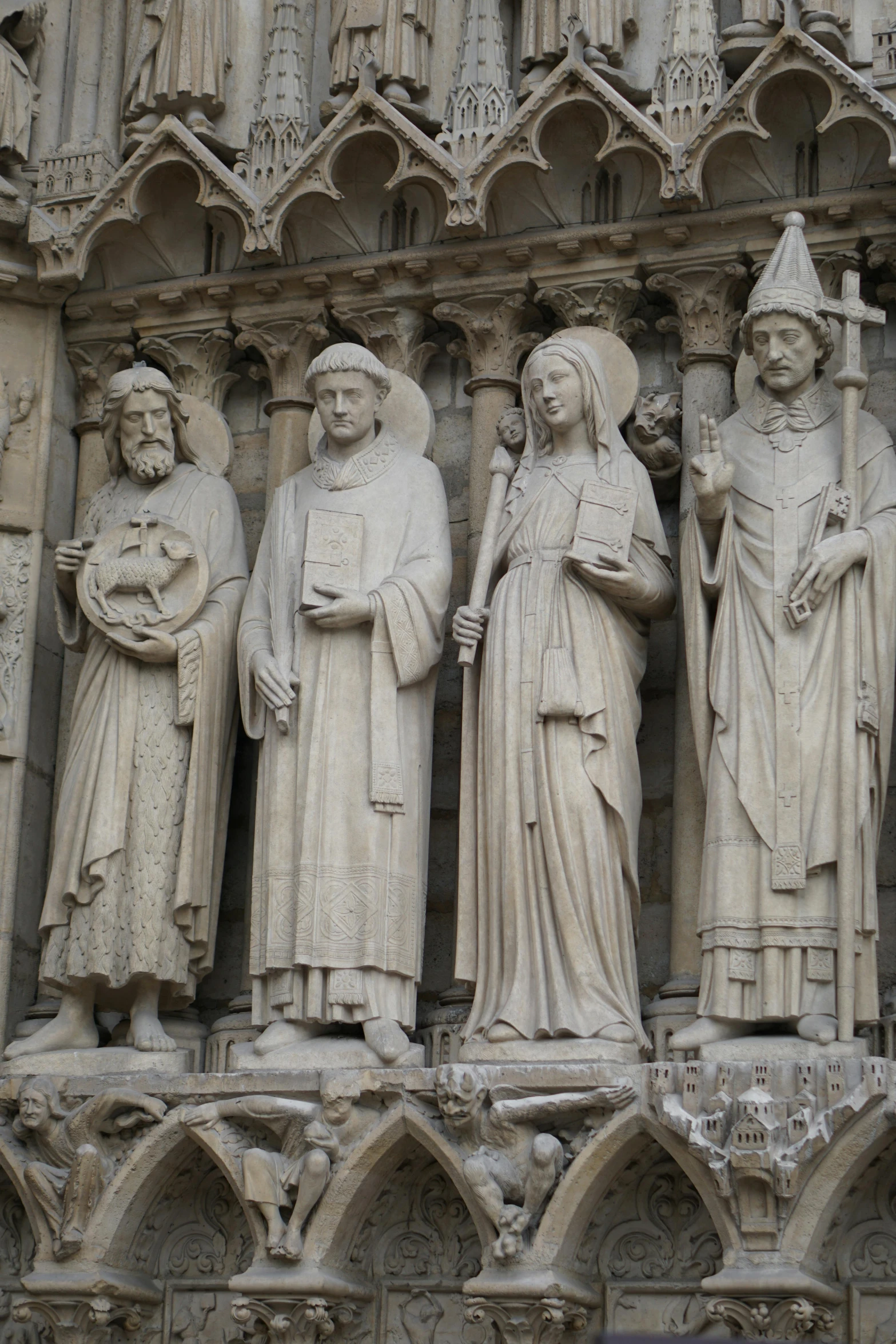 a group of statues on the side of a building, a statue, by Louis Hersent, romanesque, grey robes, religious awe, arc