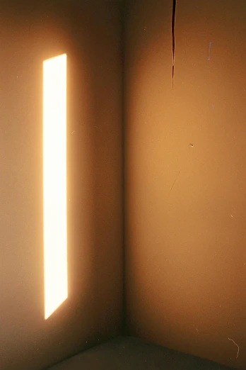 a corner of a room with a light coming through the window, inspired by Jan Rustem, unsplash, light and space, 1977, defective fluorescent lighting, ambient amber light, medium format. soft light