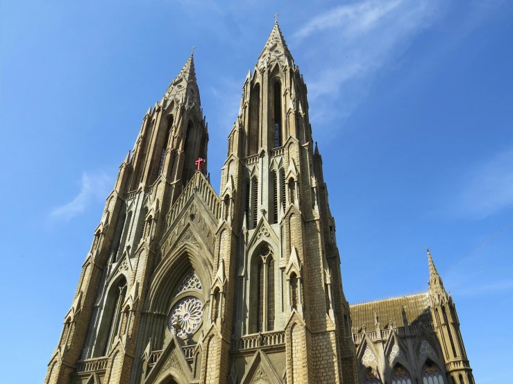 a large cathedral with a clock on the front of it, pexels contest winner, quito school, khajuraho, three towers, blue sky, detmold charles maurice