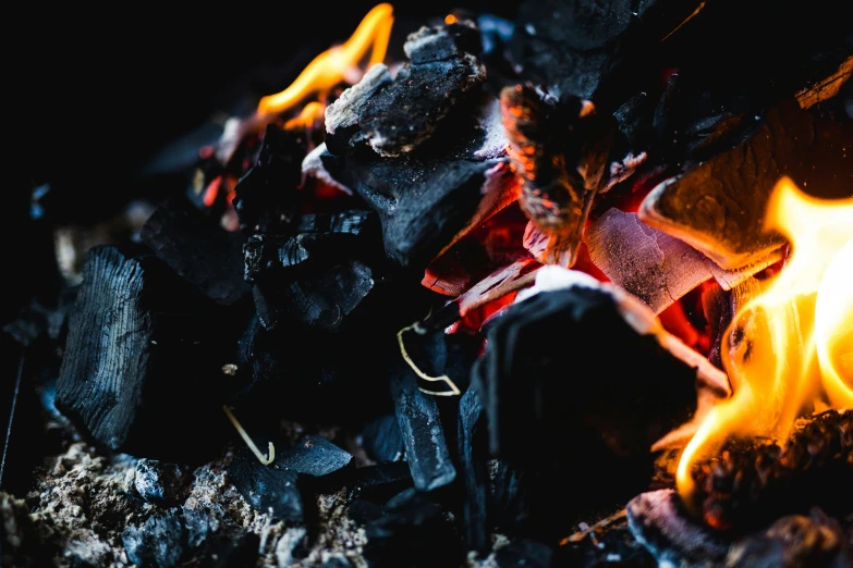 a close up of a fire in the dark, pexels contest winner, black and terracotta, smouldering charred timber, barbecue, black opals