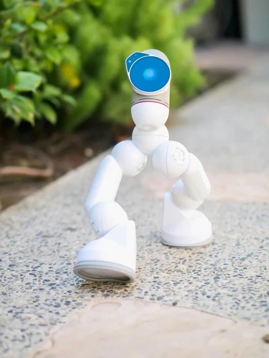 a white robot sitting on top of a sidewalk, vine twist, posable pvc, very award - winning, professional product photo