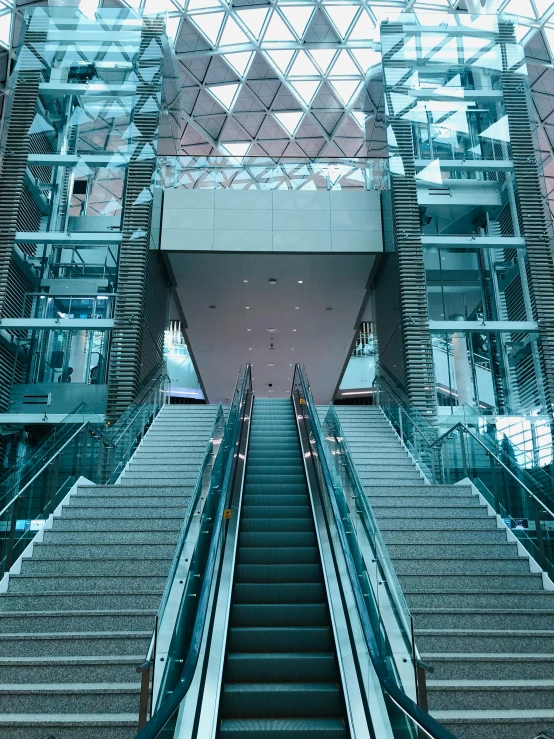 an escalator and some stairs in a building, inspired by Thomas Struth, pexels contest winner, thumbnail, with shiny glass buildings, set on singaporean aesthetic, cinematic composition 8 k