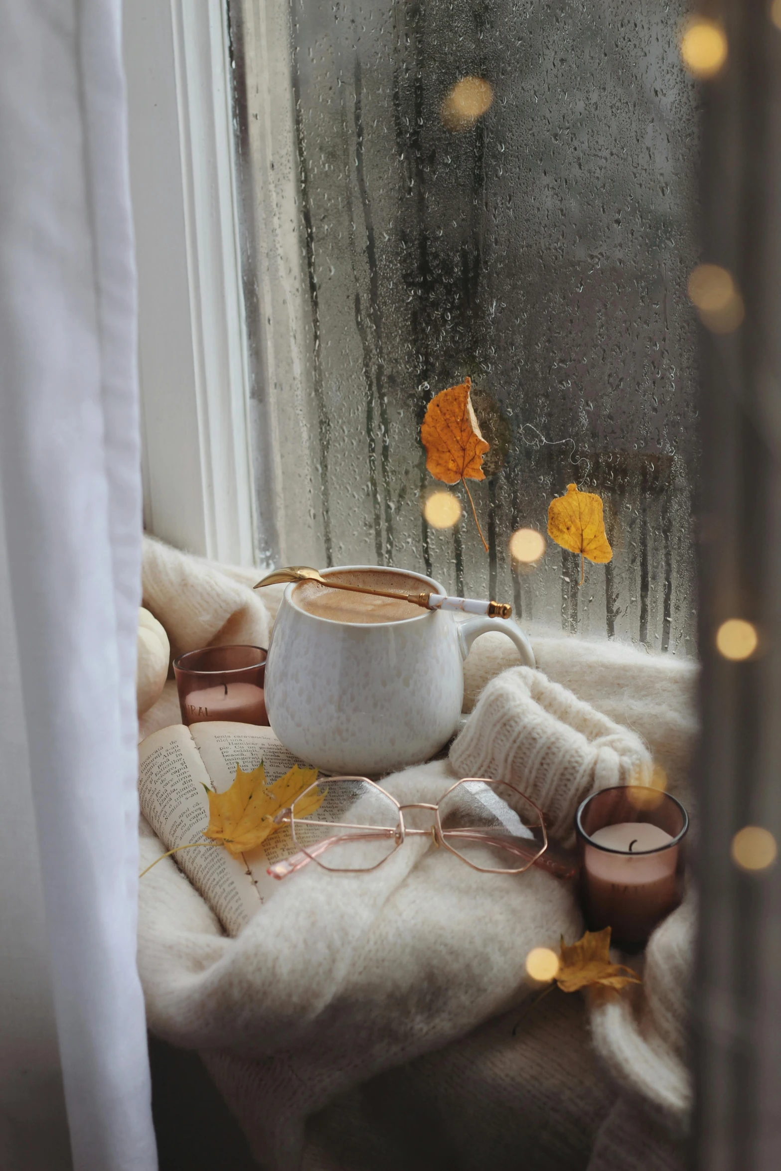 a cup of coffee sitting on top of a window sill, a picture, inspired by Elsa Bleda, trending on pexels, soft diffuse autumn lights, ivory and copper, 🍂 cute, promo image