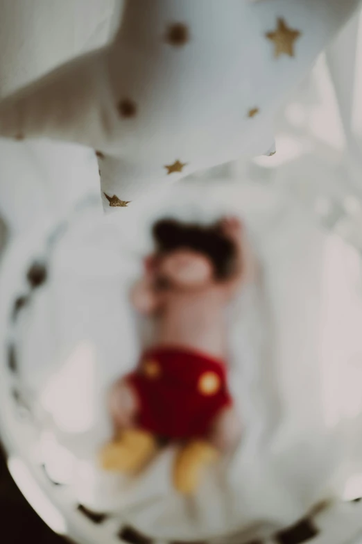 a close up of a stuffed animal on a plate, pexels contest winner, magical realism, wide angle portrait of astroboy, hanging from the ceiling, dreamy blurred lens, gif