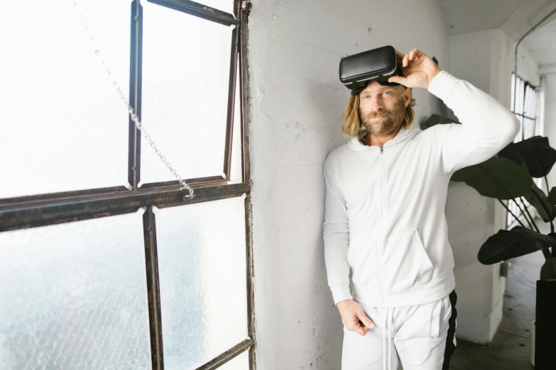 a man standing next to a window wearing a virtual reality headset, unsplash, renaissance, wearing fitness gear, greg olsen, off - white collection, wearing goggles