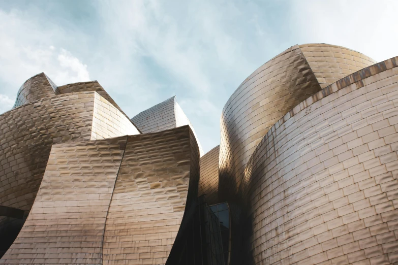 a close up of a building with a sky background, inspired by Christo, pexels contest winner, whirling gasses, bongos, golden curve structure, spain rodriguez