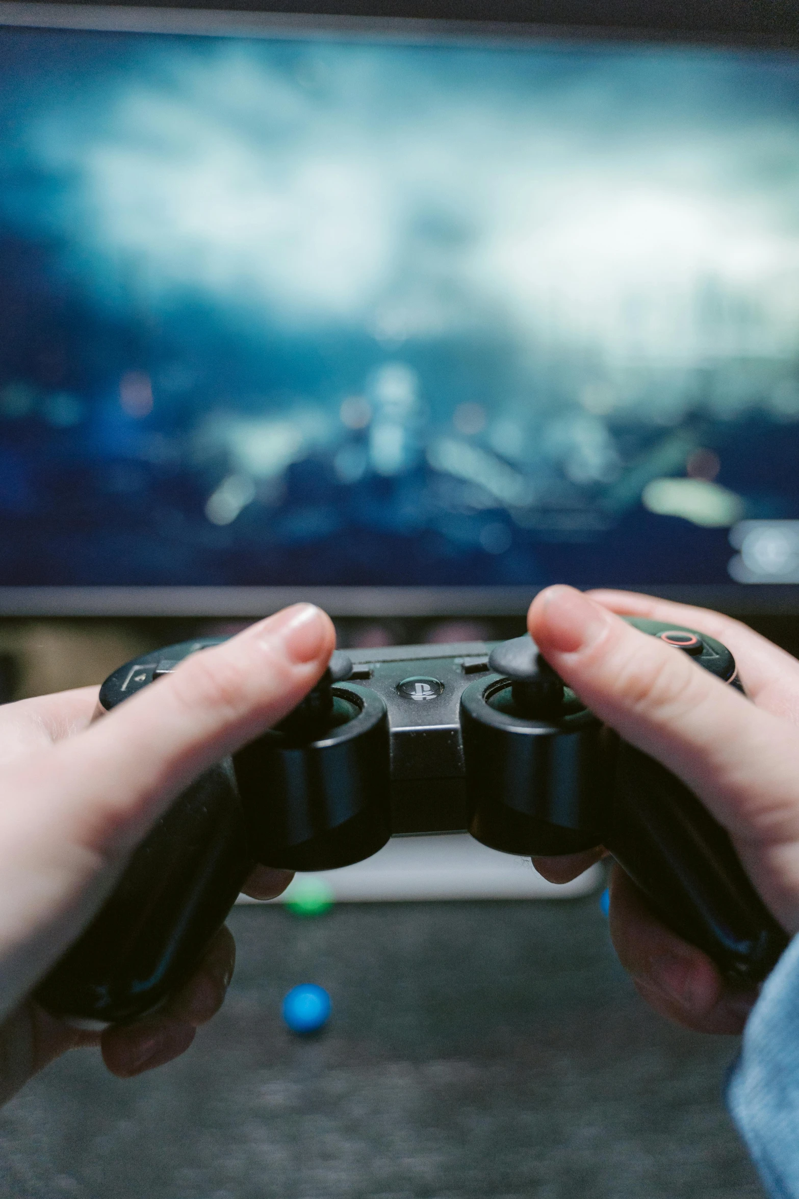 a person holding a video game controller in front of a tv, pexels, large computer monitor, headshot, educational, playstation