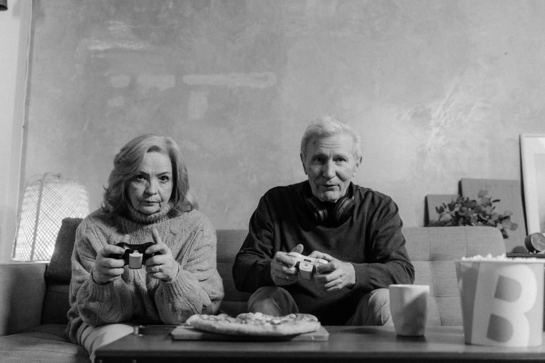 a black and white photo of two people sitting on a couch, game ready, people inside eating meals, aging, playstation