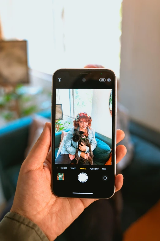 a person taking a picture with their cell phone, a picture, trending on pexels, holding a pug for a picture, home photography portrait, focus on two androids, a brightly colored