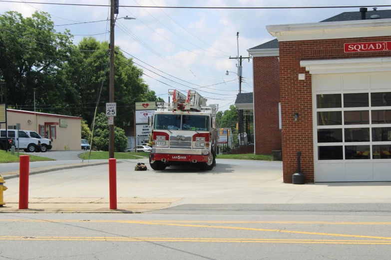 a fire truck parked in front of a fire station, by Carey Morris, square, low quality photo, chesley, view from bottom