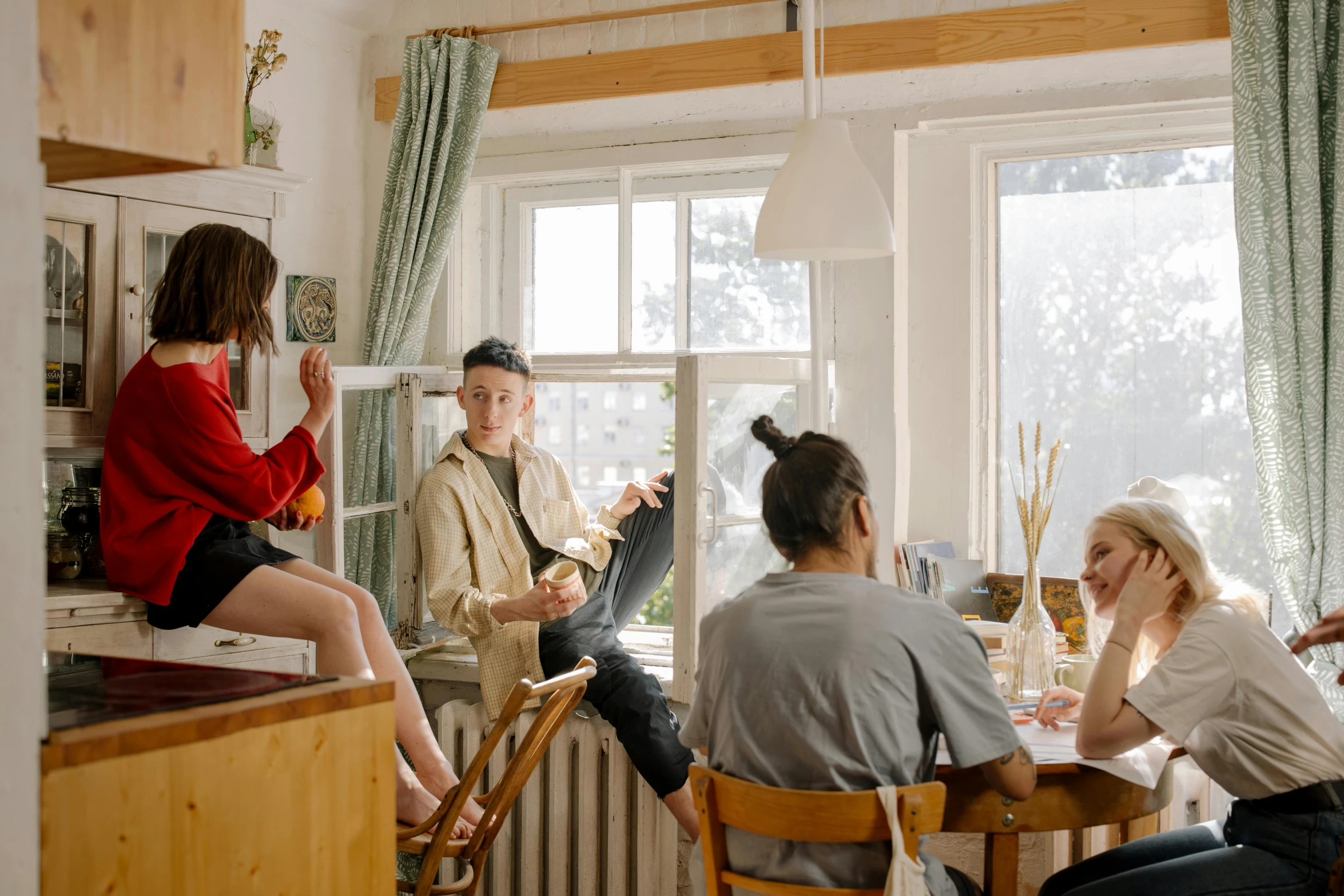 a group of people sitting around a kitchen table, pexels contest winner, balcony scene, college, mixed art, low quality photo