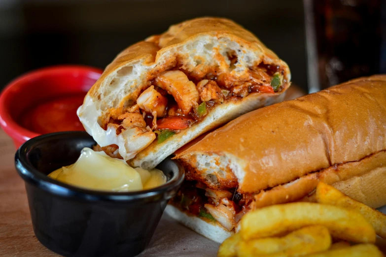 a sandwich sitting on top of a wooden table next to french fries, by Joe Bowler, pexels contest winner, kebab, grilled chicken, thumbnail, background image