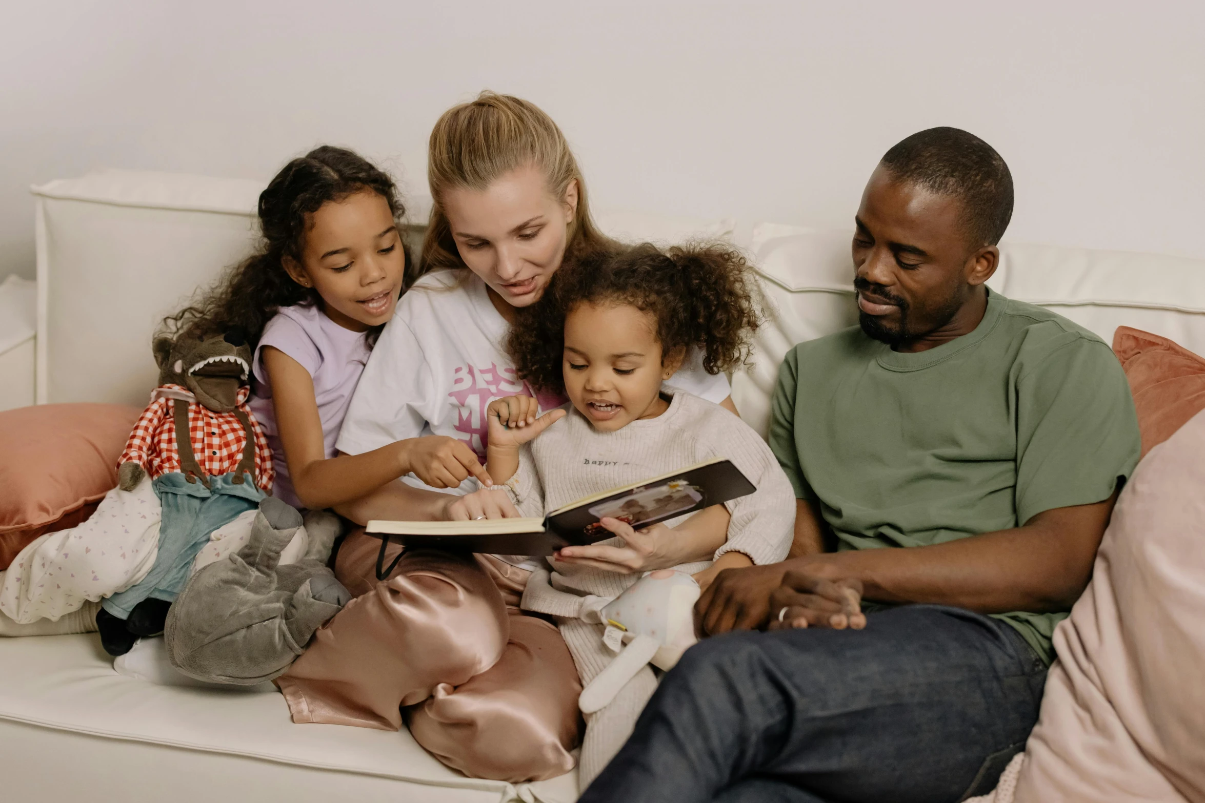 a family sitting on a couch reading a book, a picture, pexels, happening, diverse outfits, drawing for children, black people, portrait image