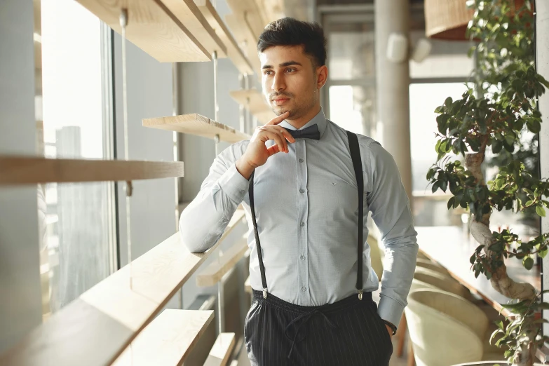 a man in a dress shirt and suspenders poses for a picture, inspired by Ramon Pichot, trending on pexels, standing in a restaurant, artem chebokha, young male, thumbnail