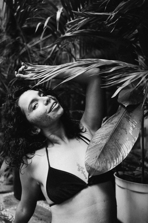 a black and white photo of a woman in a bikini, a black and white photo, by Felix-Kelly, plants, waving and smiling, yael shelbia, ((portrait))