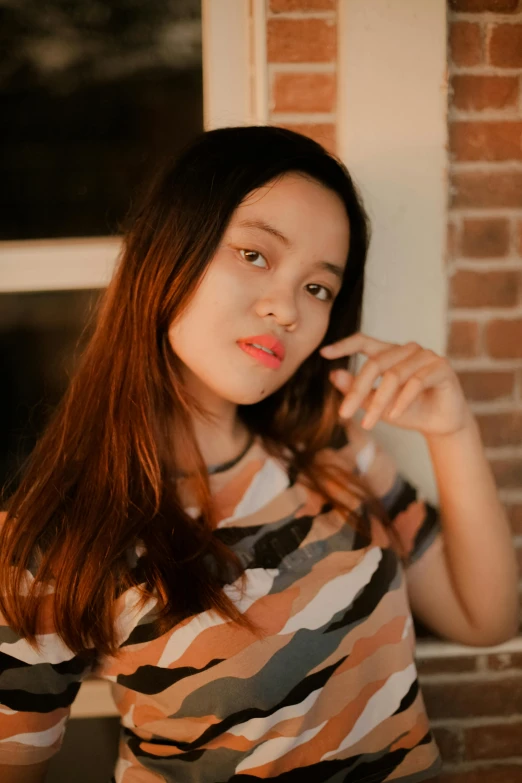 a woman brushing her teeth in front of a window, inspired by Ruth Jên, pexels contest winner, realism, young cute wan asian face, she has long orange brown hair, evening time, mai anh tran