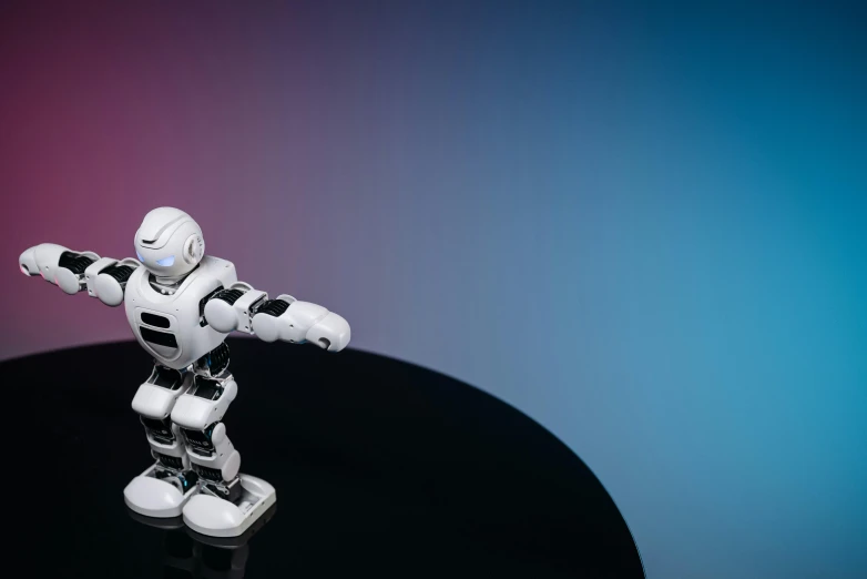 a close up of a toy robot on a table, a 3D render, unsplash, 3 d render n - 9, fan favorite, striking pose, programming