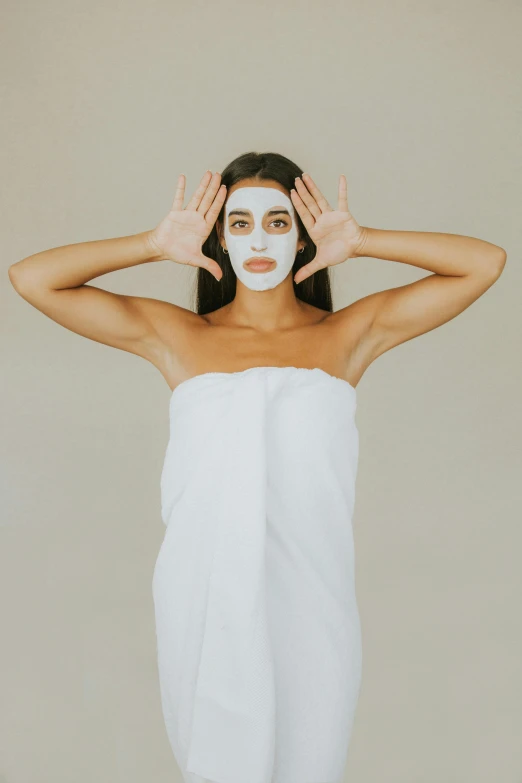 a woman with a towel wrapped around her head, trending on pexels, renaissance, face mask, frontal pose, mid body shot, white facepaint